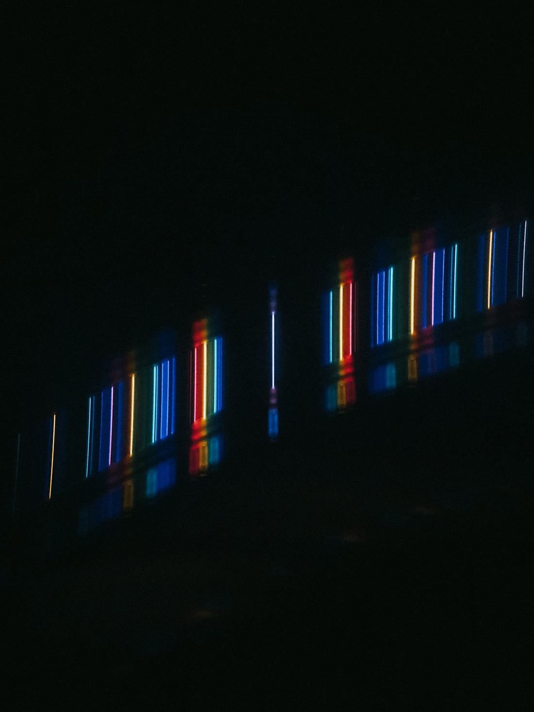 a dark room with some lights on the wall